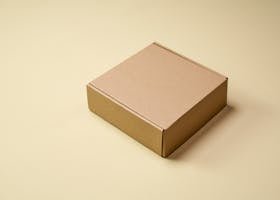 Simple cardboard box displayed on a neutral surface, ideal for product packaging visuals.